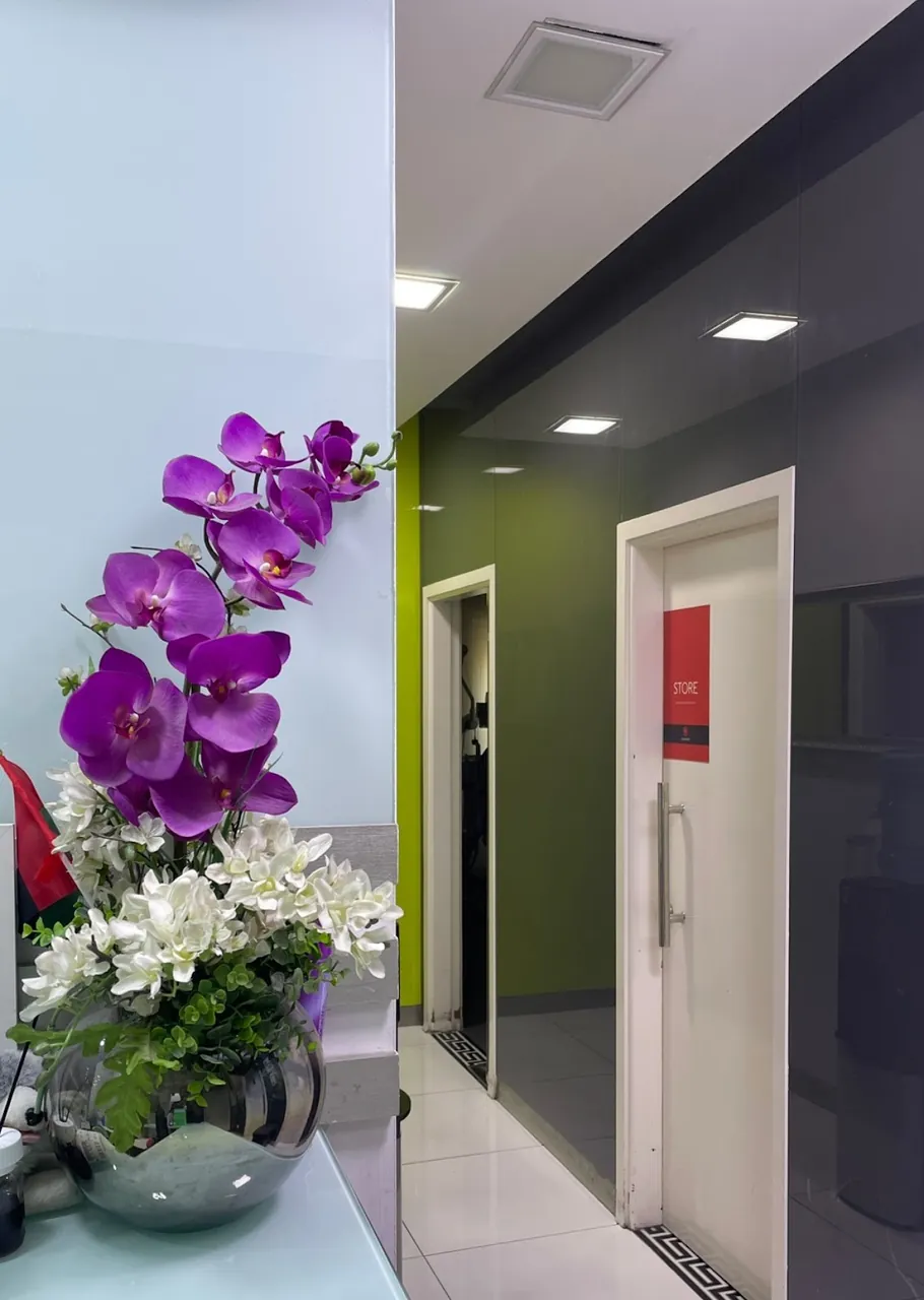 Corridor with an orchid arrangement and room doors